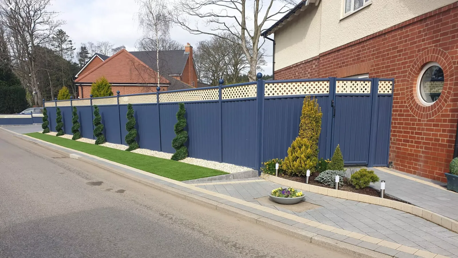 Blue ColourFence panels enclosing a garden