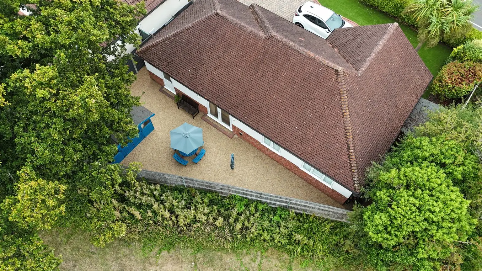 Overhead view of bespoke resin patio in Poole, Dorset, blending seamlessly with new garden furniture and vibrant UV-stable finish.