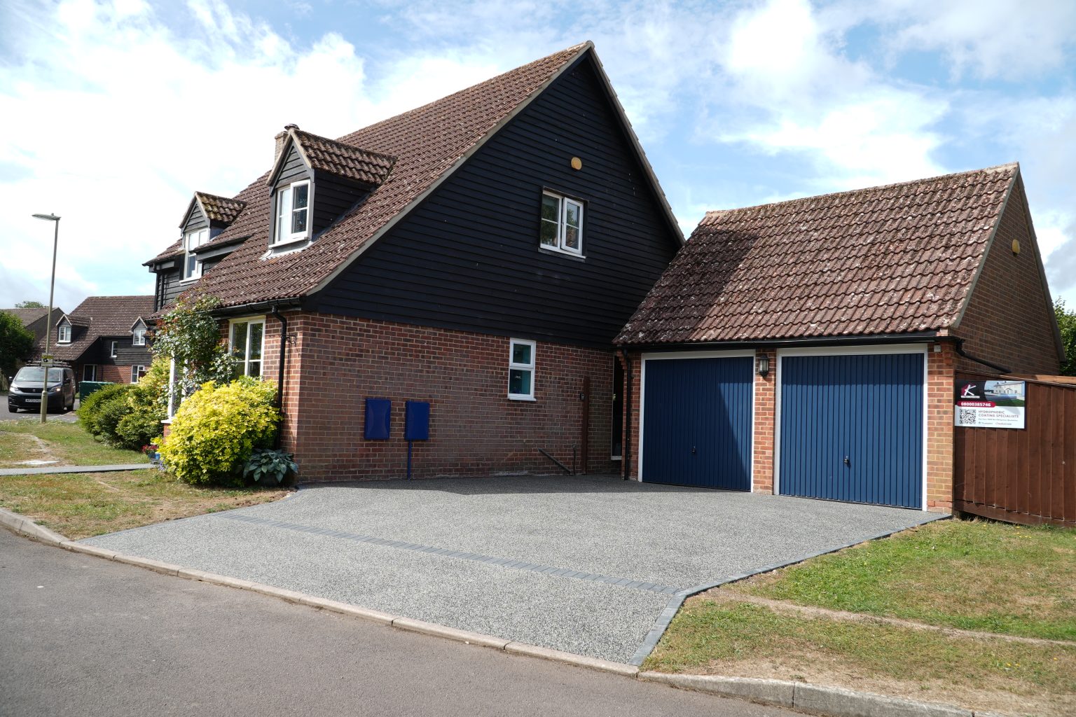 Side angle of Kingsclere resin driveway with Harlequin black and white fleck, installed by Kola Construction for durability and seamless style.