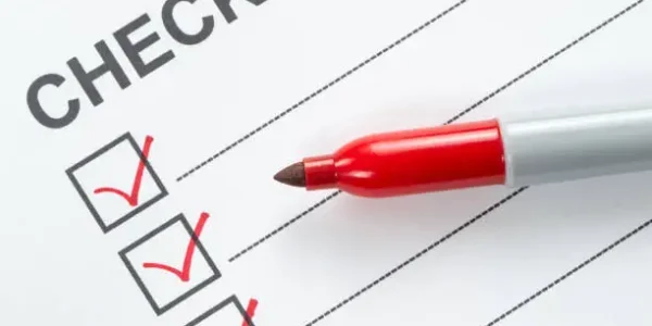 Red marker pen marking on checklist box, close up